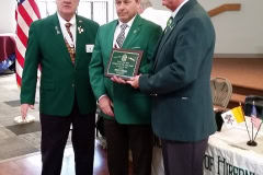 In Brother Cassidy's absence, Brothers Tim Riley and John Diehl receive the award on his behalf from State President Eugene Bransfield, Sr.